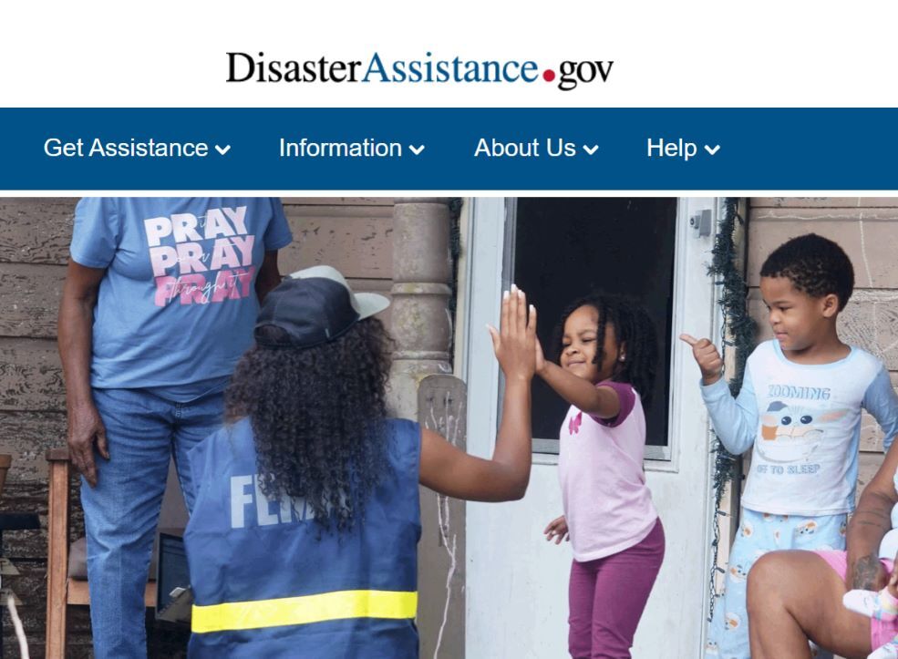 The DisasterAssistance.gov website home page depicting a FEMA worker high fiving two children.