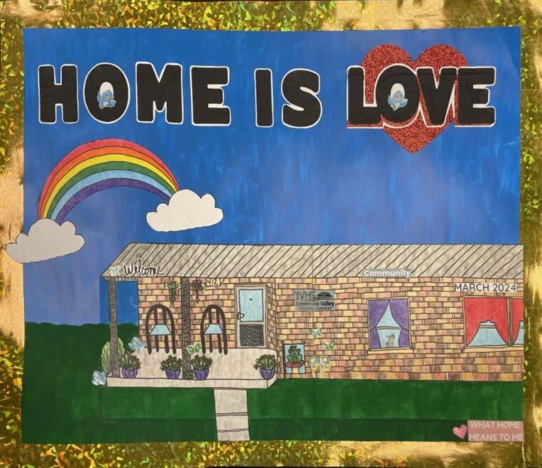 What Home Means To Me Poster Contest 2025 Calendar Cover with a brick house, a rainbow, and the words Home is Love.